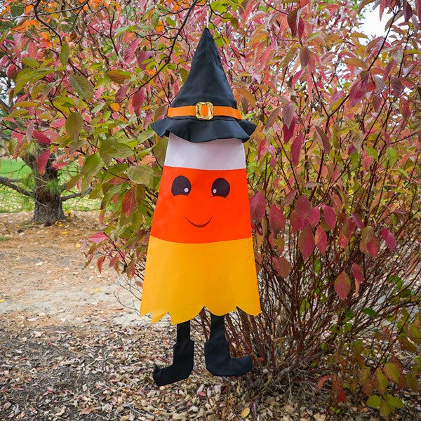 Candy Corn 3D Cone Windsock staged outdoors, swaying in the breeze as part of seasonal Halloween decor.