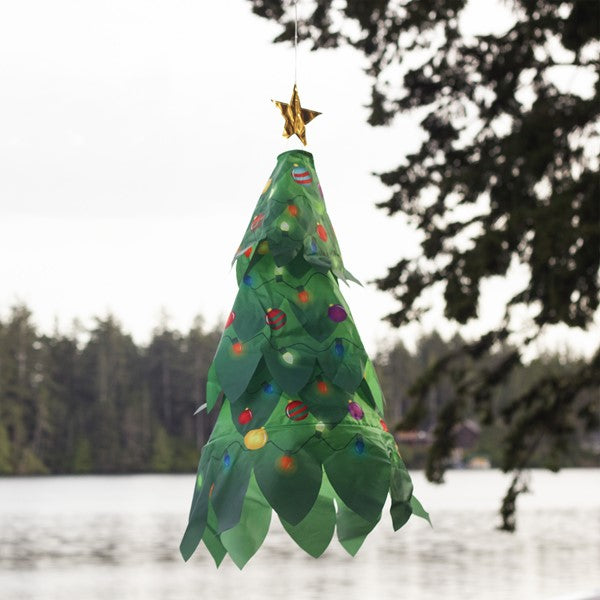 Christmas Tree 3D Windsock staged outdoors, swaying in the breeze as part of cheerful Christmas decor.