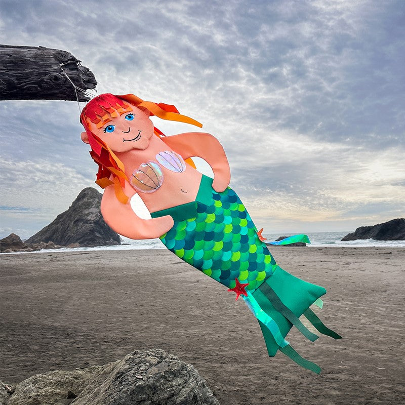 Mermaid Wind Friend fluttering outdoors, adding a magical and seaside touch to your garden or patio, ideal for coastal or beach-themed spaces.