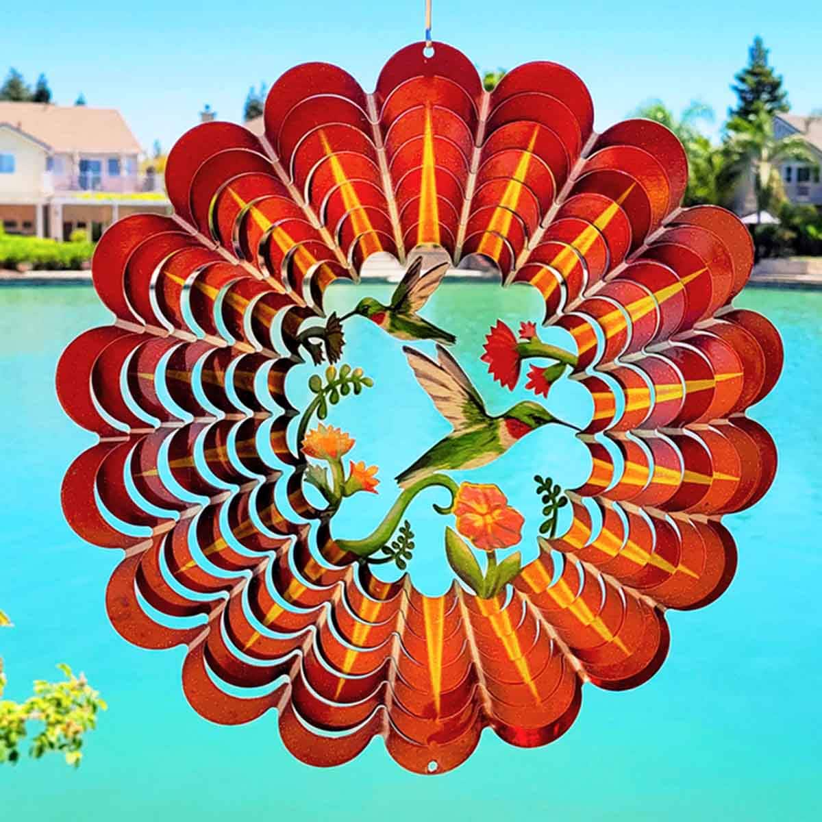 Outdoor 12" 3D Hummingbird Wind Spinner made from powder-coated stainless steel, featuring a vibrant hummingbird design and captivating 3D motion for outdoor décor.