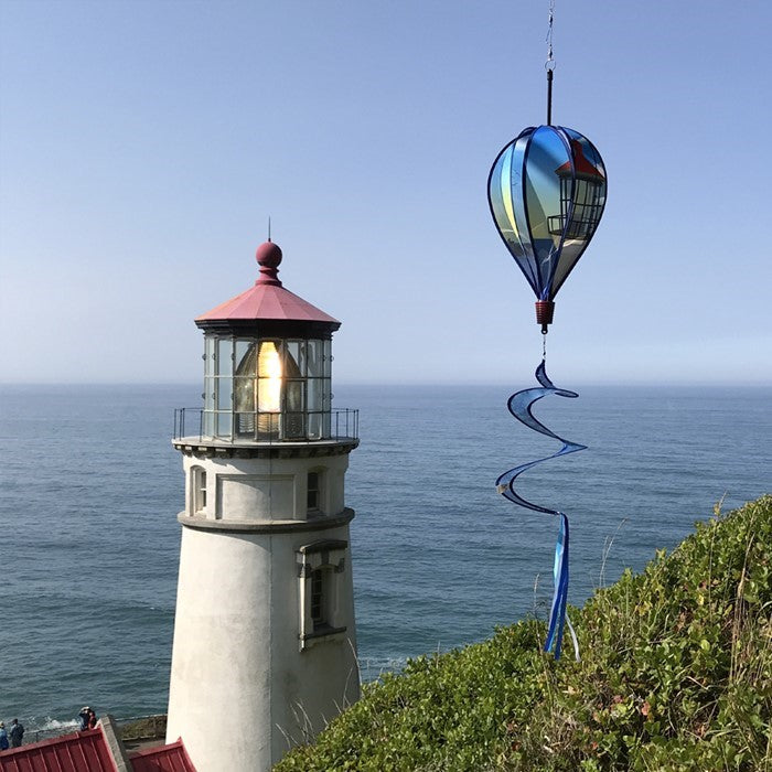 Coastal Lighthouse 6-Panel Hot Air Balloon staged outdoors, adding a nautical charm to the yard or garden.