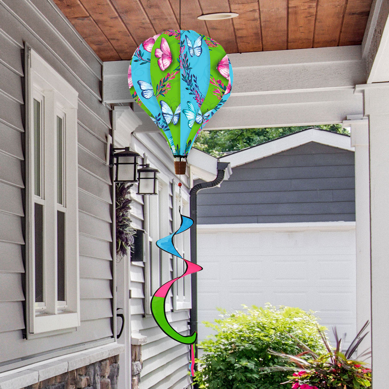 Hot air balloon spinner with colorful butterflies, durable polyester, and flowing tail for breezy spring and summer garden or patio décor.