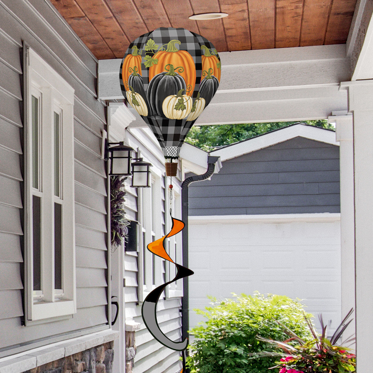 Hot air balloon spinner with checkered pumpkins, durable polyester, and harvest-inspired motion for festive outdoor fall decorating.