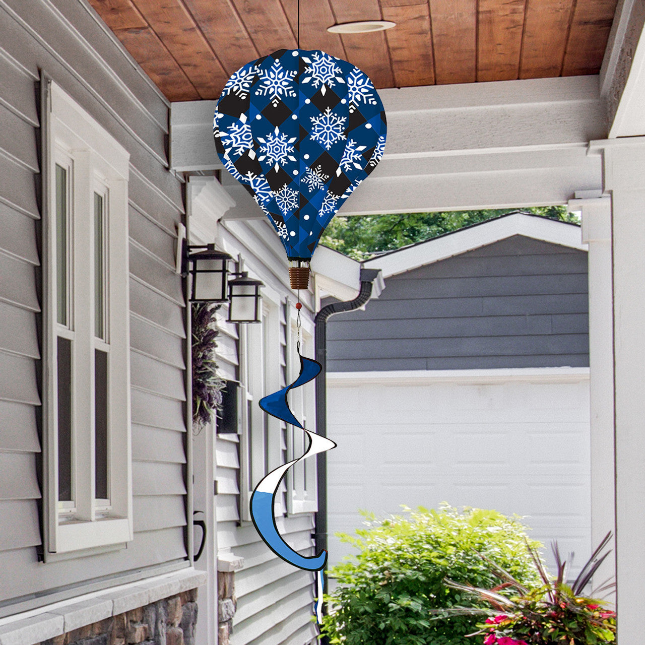 Hot air balloon spinner with snowflakes on buffalo plaid, crafted from weather-resistant polyester for festive, breezy winter and holiday outdoor décor.