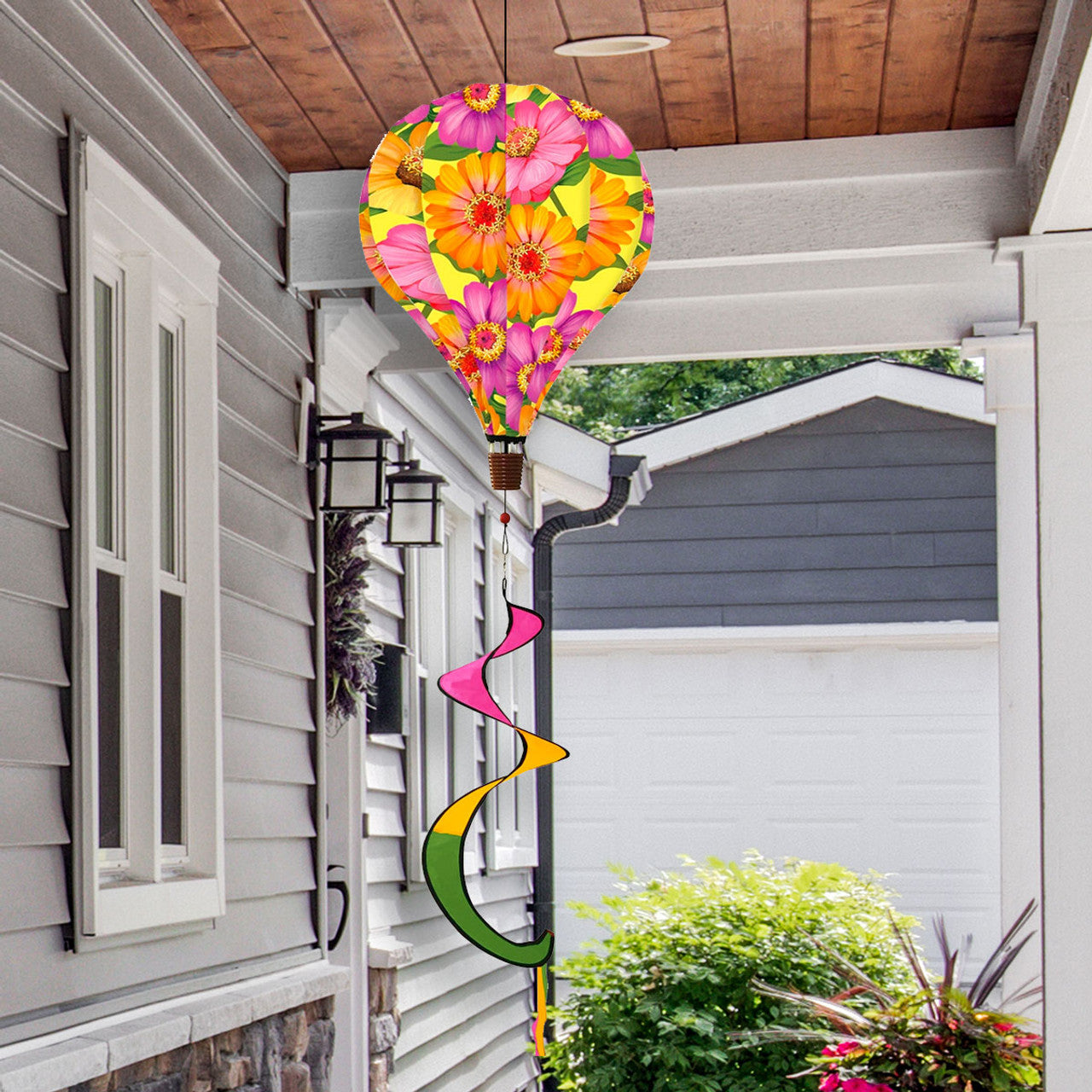 Hot air balloon spinner with white daisies and soft pastels, crafted from weather-resistant polyester for fresh, breezy spring and summer garden décor.