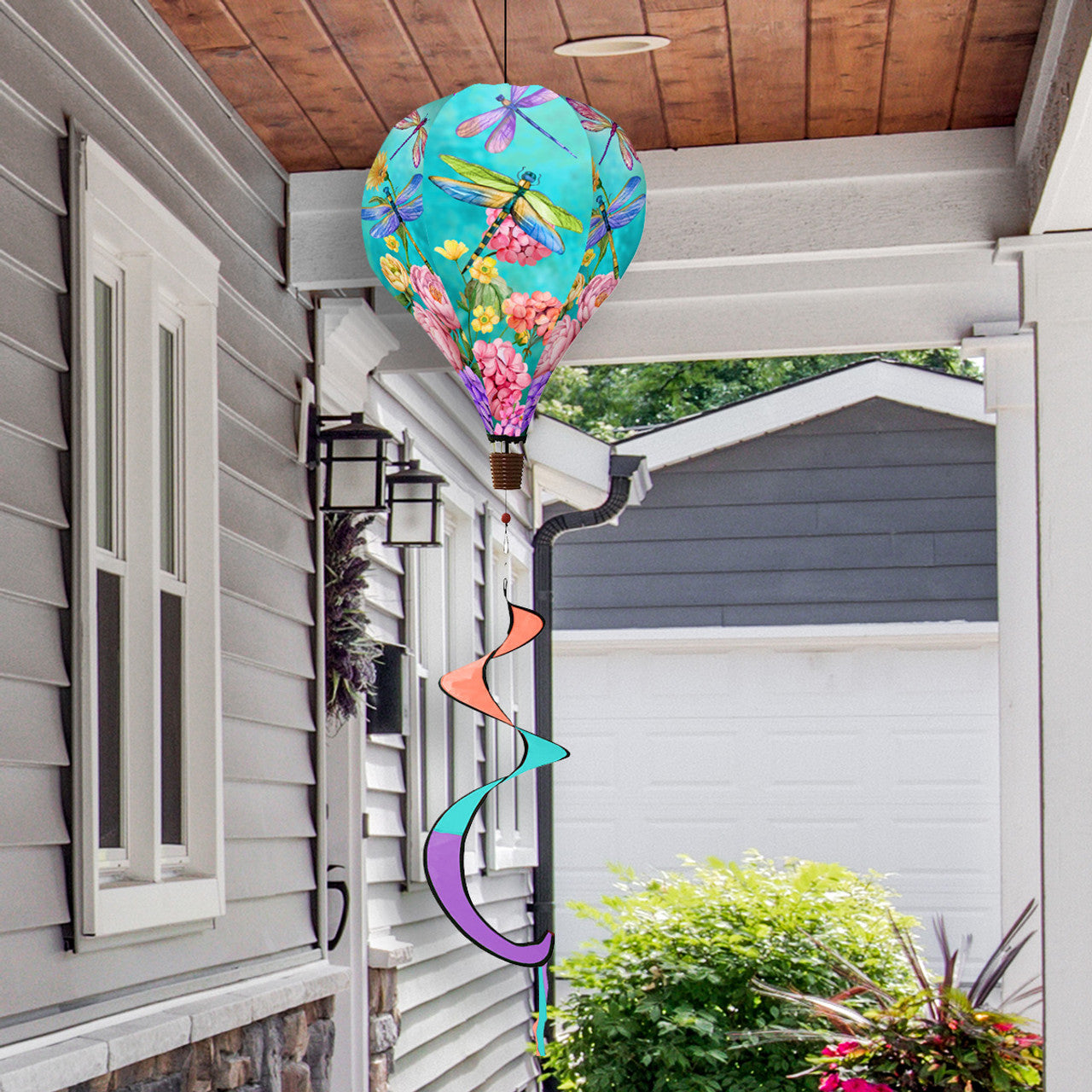 Hot air balloon spinner with dragonflies and blooming flowers, crafted from weather-resistant polyester for elegant spring and summer garden décor in motion.