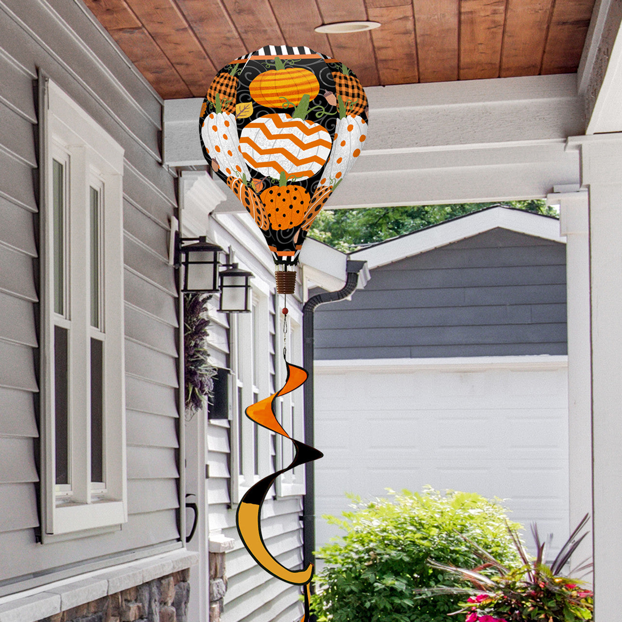 Hot air balloon spinner with pumpkins, autumn leaves, and vibrant fall colors, made of weather-resistant polyester for festive outdoor harvest-themed décor.