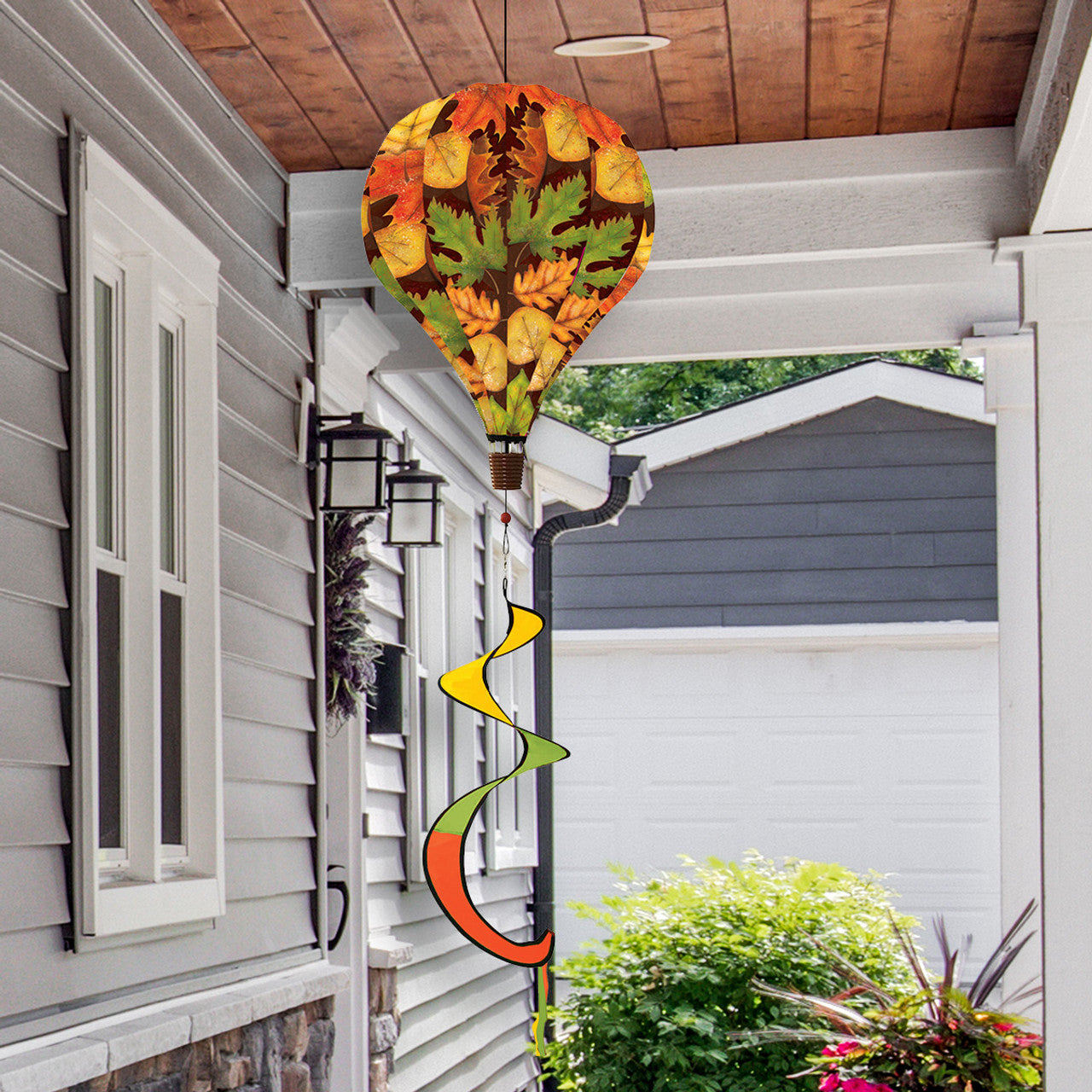 Hot air balloon spinner with colorful autumn leaves design, made of weather-resistant polyester for breezy, festive fall garden or porch décor.