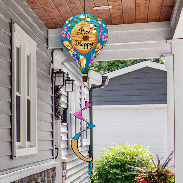 Hot air balloon spinner with buzzing bees, floral accents, and golden beehive design in weather-resistant polyester for joyful, breezy outdoor garden décor.