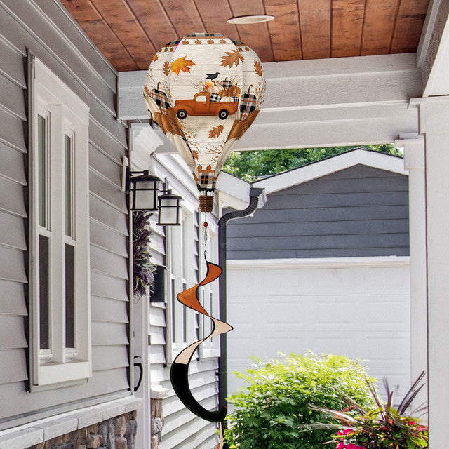 Hot air balloon spinner with vintage pickup truck, pumpkins, and fall florals, made of weather-resistant polyester for breezy, festive autumn outdoor décor.