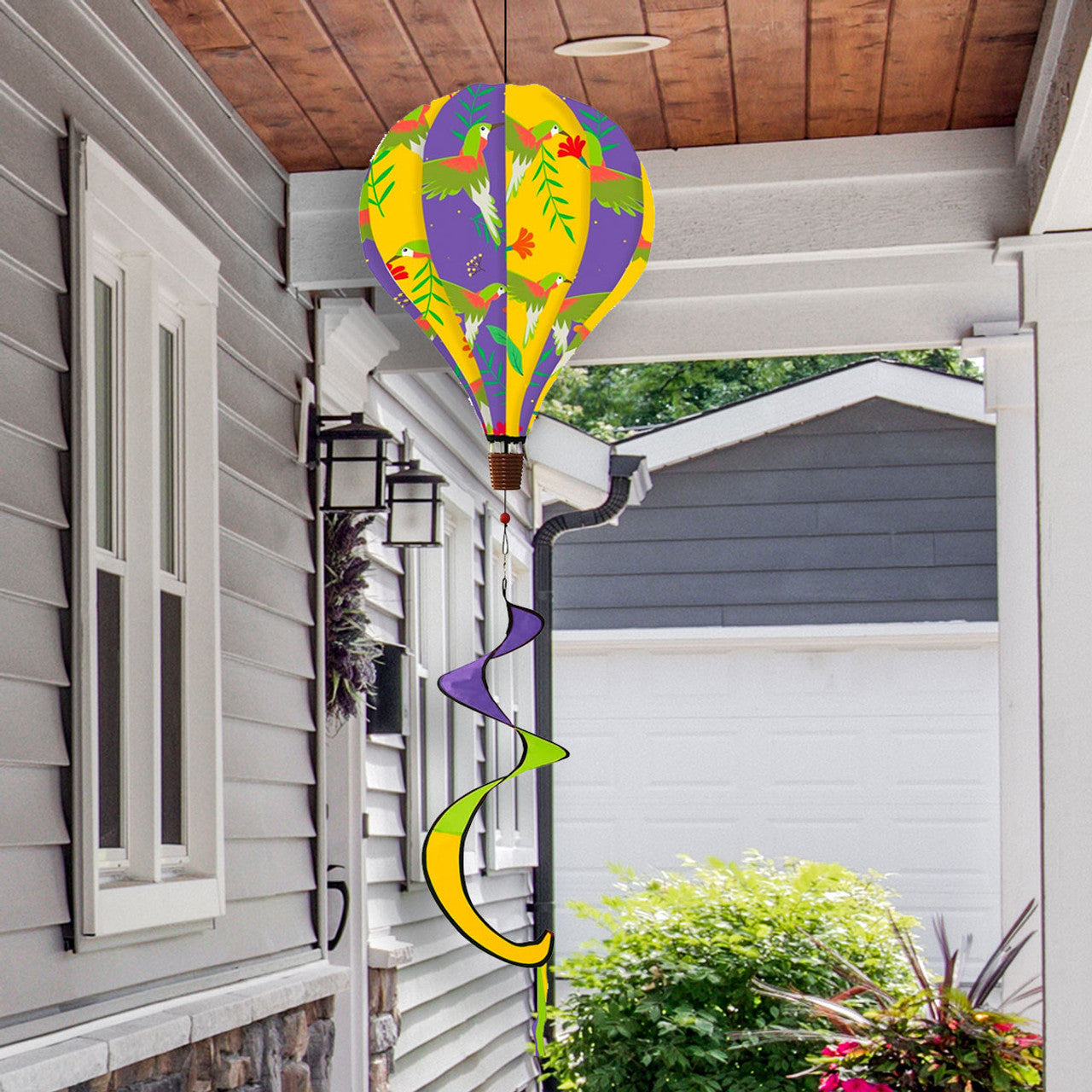 Hot air balloon spinner with hummingbirds and flowers, durable polyester design, and graceful spinning tail for vibrant nature-inspired outdoor décor.