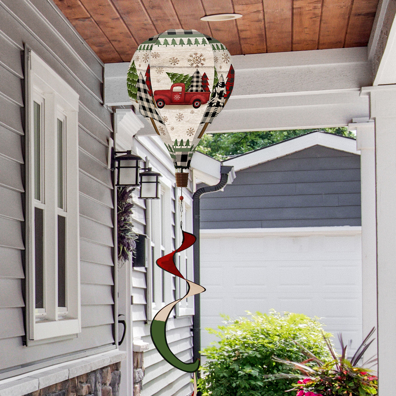 Hot air balloon spinner with red vintage Christmas truck, tree, and gifts, made of weather-resistant polyester for festive outdoor holiday garden décor.