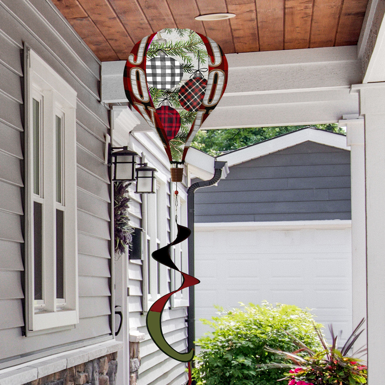 Hot air balloon spinner with festive patterned ornaments, crafted from weather-resistant polyester for elegant, breezy holiday garden or porch decoration.