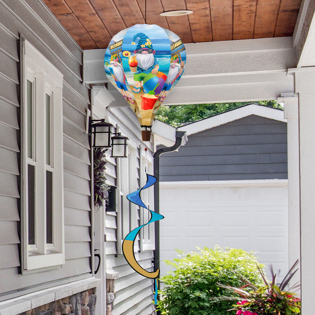 Hot air balloon spinner with tropical summer gnomes, beach elements, and weather-resistant polyester for vibrant, breezy outdoor summer garden décor.
