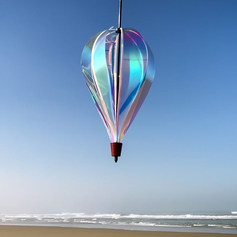 Iridescent 6-Panel Hot Air Balloon displayed outdoors, featuring its radiant, multicolored sheen against a bright, open sky.