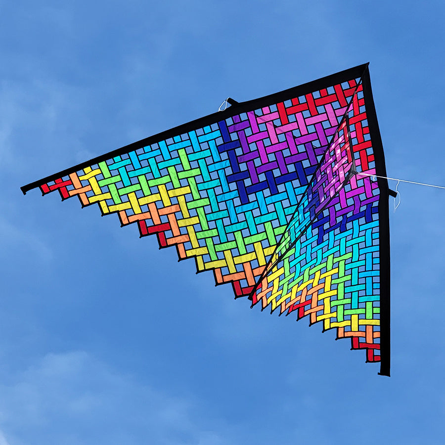 Oversized rainbow delta kite with colorful mesh pattern and durable carbon frame, perfect for beach flying in 5–20 mph winds.