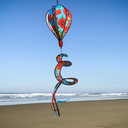 Red Poppies 6-Panel Hot Air Balloon displayed outdoors, showcasing its vibrant floral design against a clear, picturesque sky.