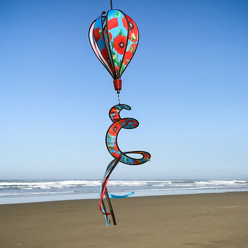 Red Poppies 6-Panel Hot Air Balloon displayed outdoors, showcasing its vibrant floral design against a clear, picturesque sky.