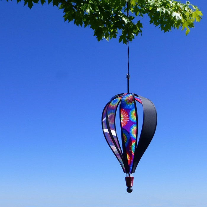 Tie Dye 6-Panel Hot Air Balloon soaring outdoors, featuring its dazzling tie-dye design against a clear, open sky.